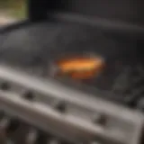 Close-up view of a gas grill burner before cleaning