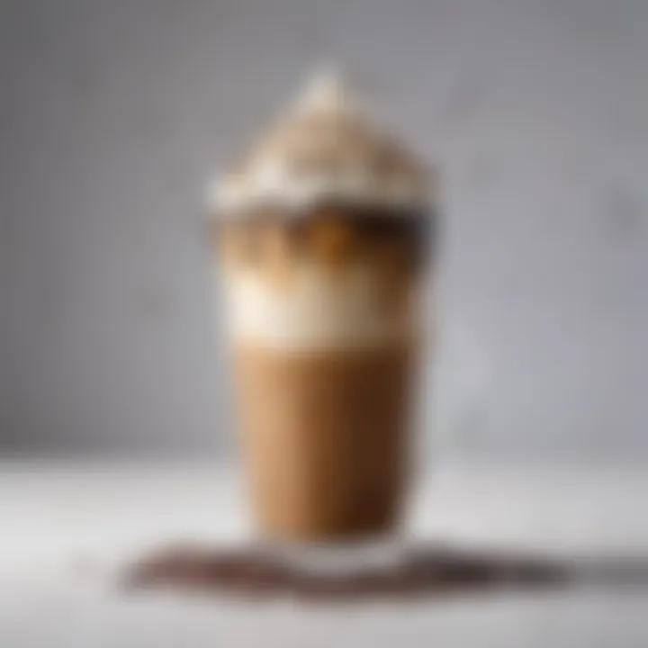 A close-up of a deliciously frothy iced coffee topped with whipped cream and chocolate drizzle