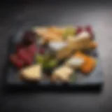 A beautifully arranged slate cheese board with a variety of cheeses and fruits