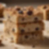 A close-up view of a freshly baked raisin oatmeal bar, showcasing its texture and color.