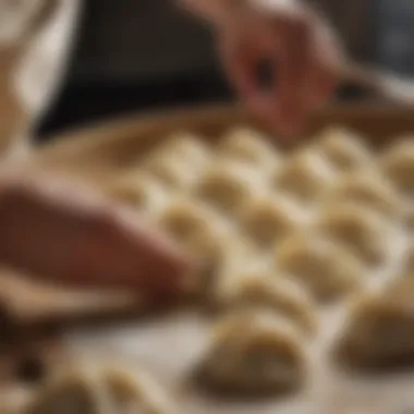 A close-up of dough being expertly shaped into dumplings