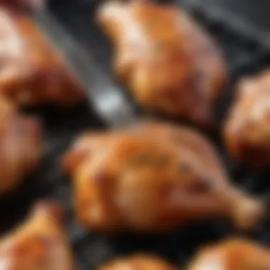 A close-up of a marinade brush applying sauce to chicken legs on the grill.