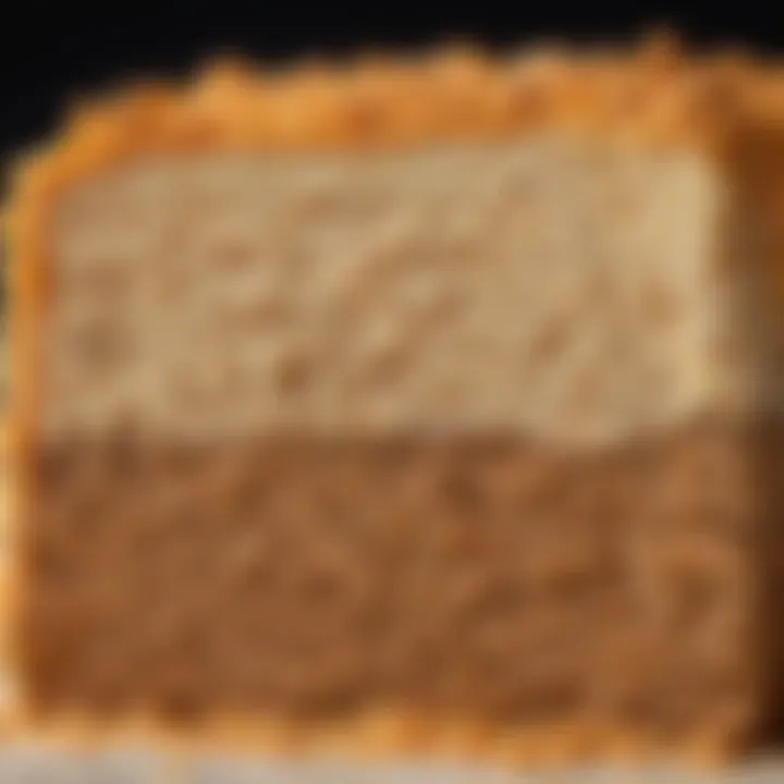 A cross-section of a Rice Krispie Scotcheroo revealing its crunchy texture and rich filling.