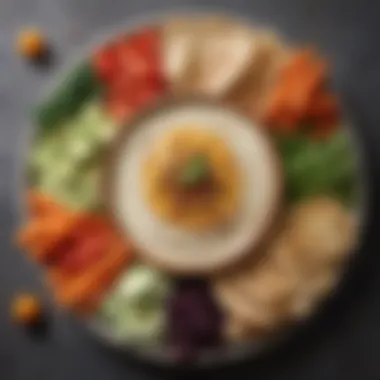 Elegant platter featuring hummus with fresh vegetables and pita bread